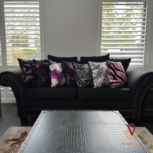victoria jane Fluttering Hydrangea Velvet Cushion with magenta moods cushion on couch