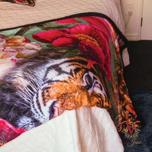 victoria jane peony tiger sherpa blanket draped over bed