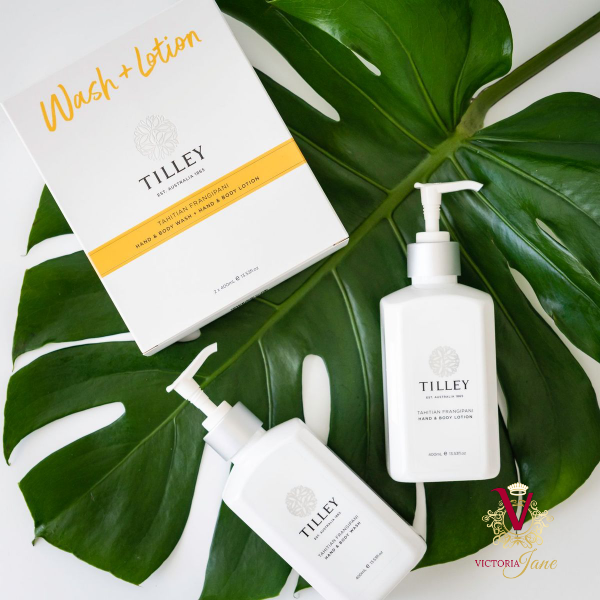 Tilley - Tahitian Frangipani Hand & Body Wash & Lotion Duo for Silky Soft Skin flat lay photoshoot on palm leaf