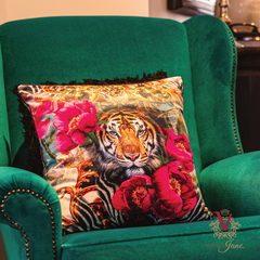 Peony Tiger Velvet Cushion on green chair