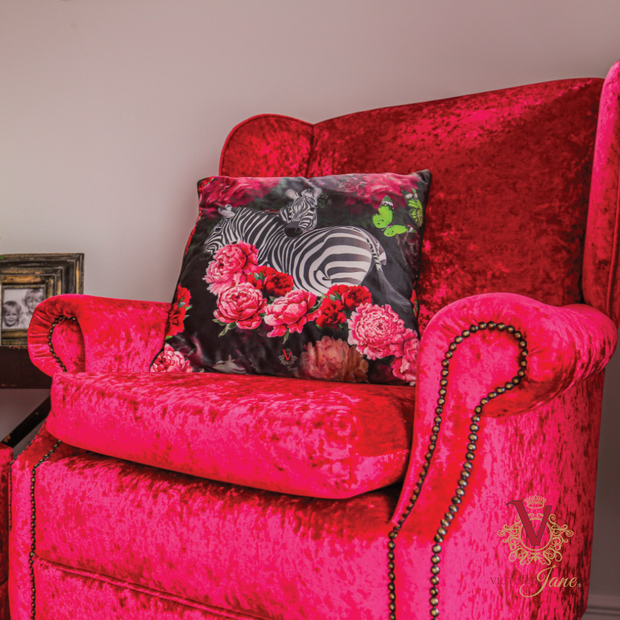 Zebra Rose Velvet Cushion in red chair victoria jane