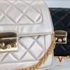 close up of ink and Champagne Metallic Quilted Cross Body Bag  with victoria jane logo