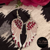 Si Belle Collections - Pink Angel Wings Earrings on leopard cushion